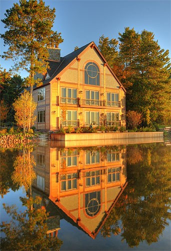 A pretty view of a timber lake house
