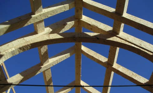 Looking up at arched timber trusses