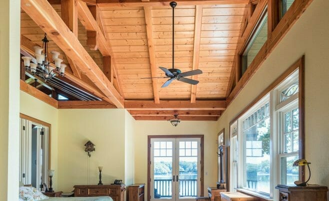 Bedroom with ceiling beams and a ceiling fan in the Wakenah Residence