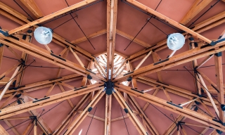 Octagon Timber Frame - looking up at exposed wood trusses