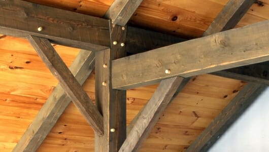 Timber Post with Brace and Rafter tie with traditional joinery in a timber frame home