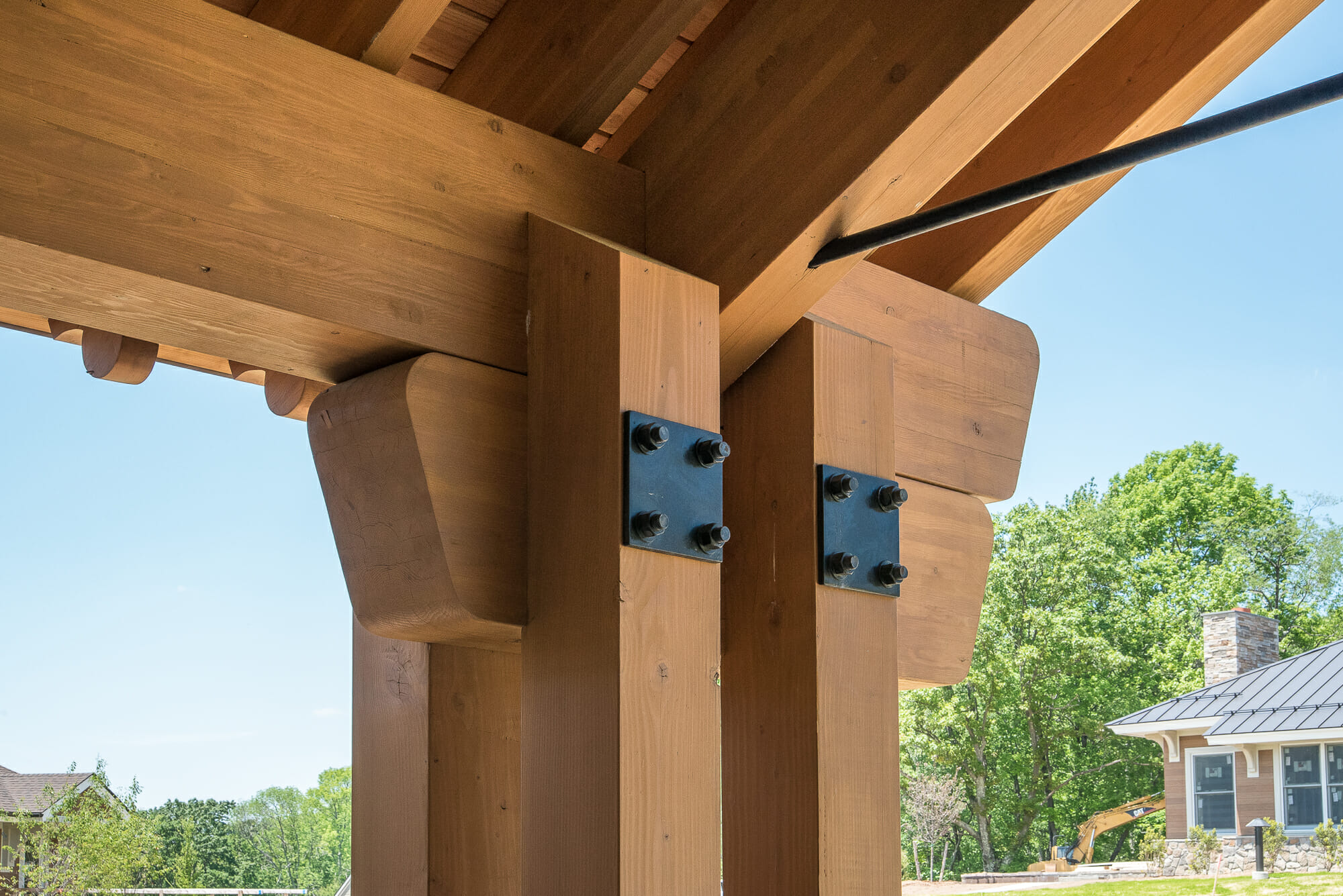 The Mahamudra Buddhist Retreat in Cragsmoor, NY has a heavy timber entryway and interior trusses fabricated from Glulam and Douglas Fir. The entryway features scrolls and black steel.