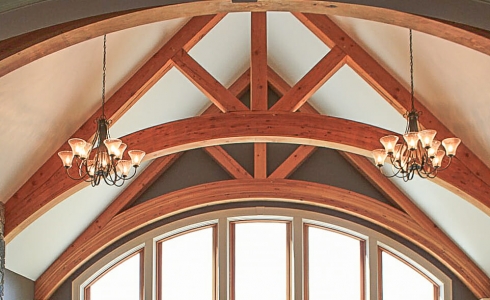 Arched glulam trusses in a custom timber home