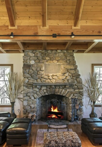 Field stone fireplace with a post and beam ceiling