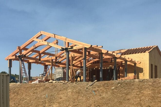 Timber frame pavilion with custom arched bottom chords under construction