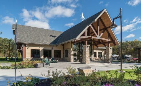 Exterior of the Adirondack Welcome Center in Queensbury, NY featuring Douglas fir Glulam Heavy Timber Trusses with steel plates.