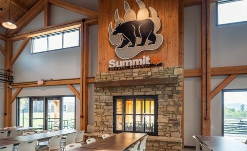 Exposed Wood Timbers Frame a Field Stone Fireplace