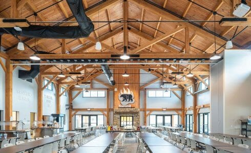 Timber Frame Dining Hall with Exposed Wood Beams and Steel Gusset Plates