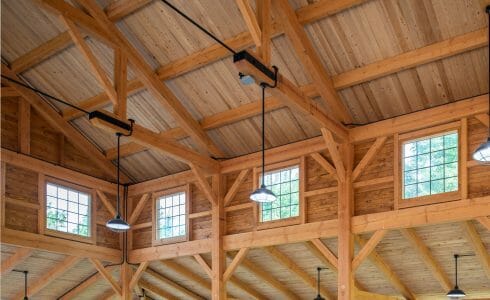 The interior of the Jack Link pavilion which features heavy timber trusses with steel plates and tie rods.