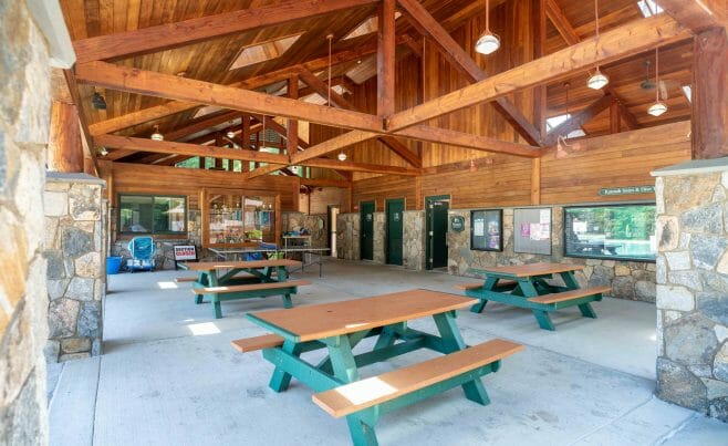 Interior of the Katonah Pool house made with a heavy timber frame and trusses with stone post bases in Katonah New York.