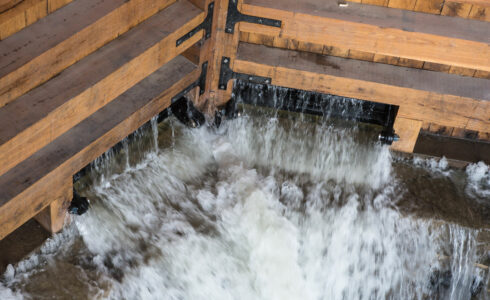 Water rushing through a closed timber frame lock gate
