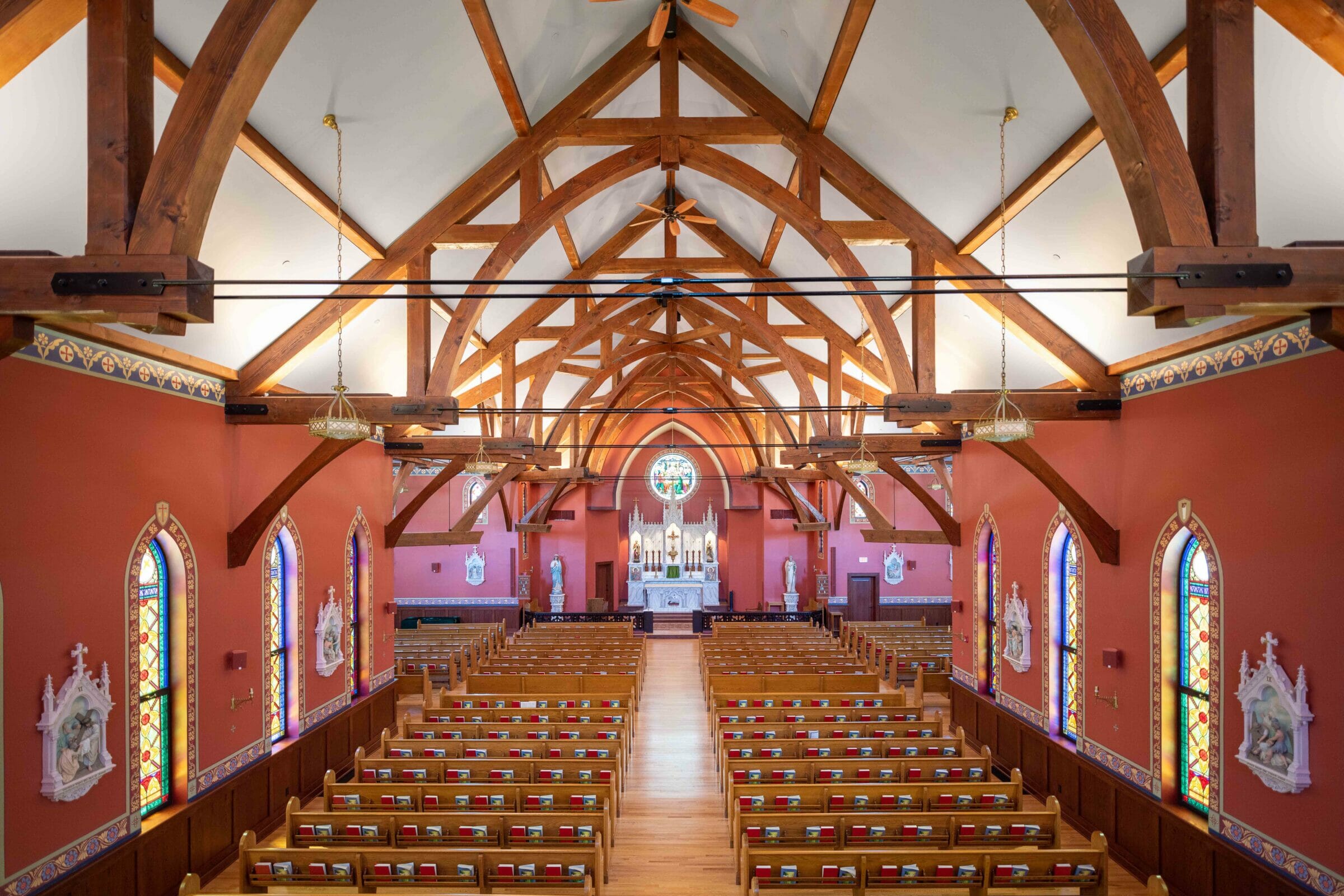 The completed interior of St. Michael's Church with arched trusses and steel tie rods