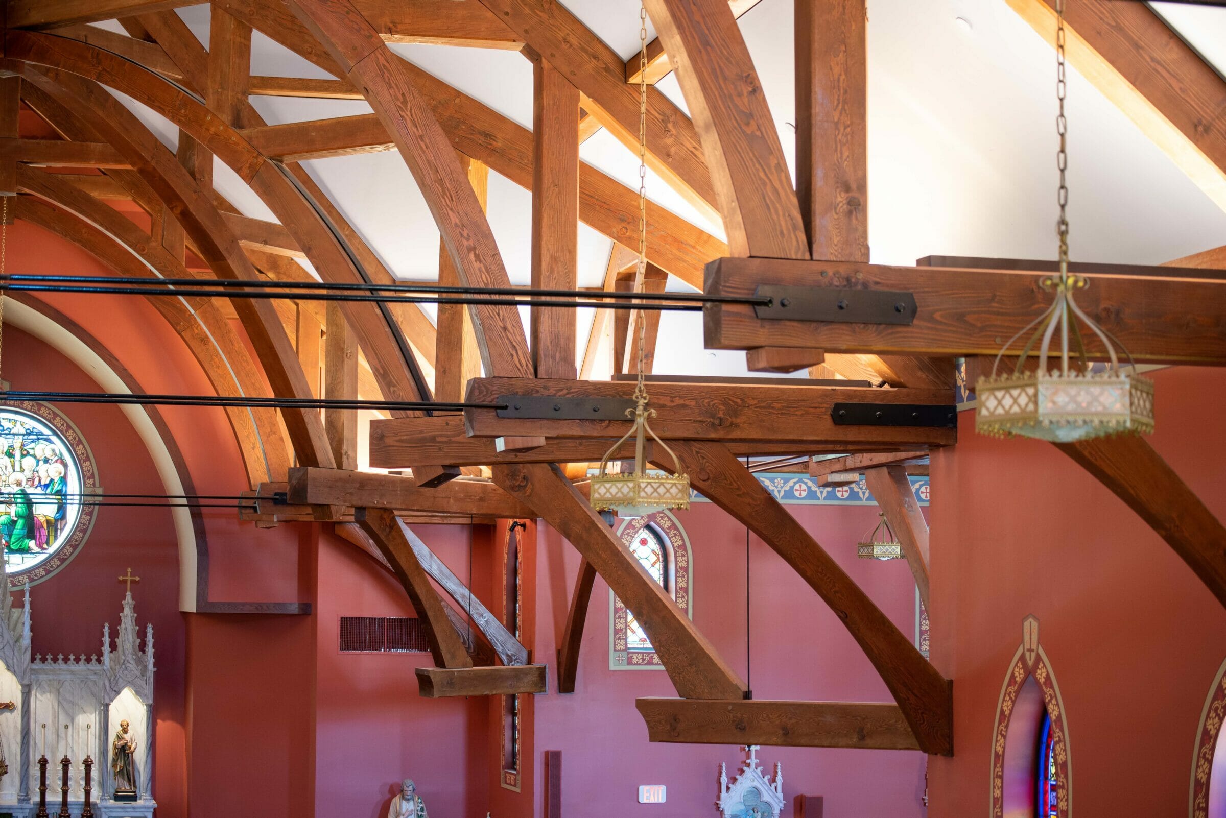 The completed interior of St. Michael's Church with arched trusses and steel tie rods