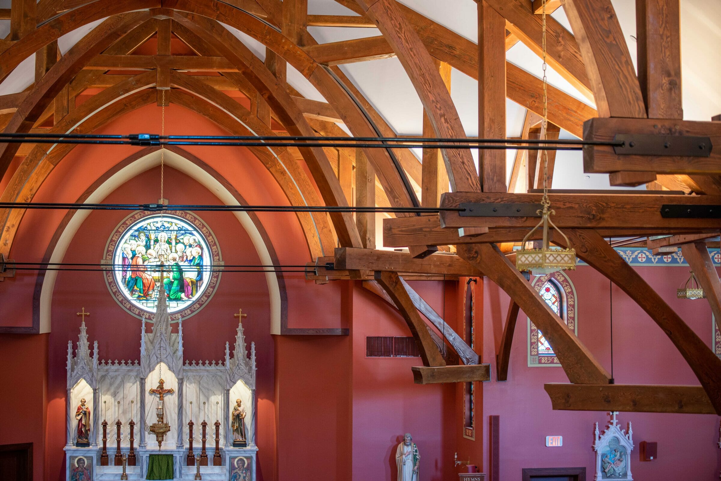 The completed interior of St. Michael's Church with arched trusses and steel tie rods