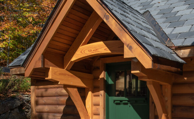 Decorative Entry Door Truss with Rafter Plates on the Exterior of a Ski House