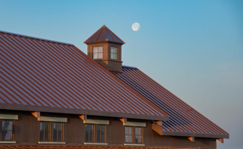 The moon coming up over a California timber framed barn