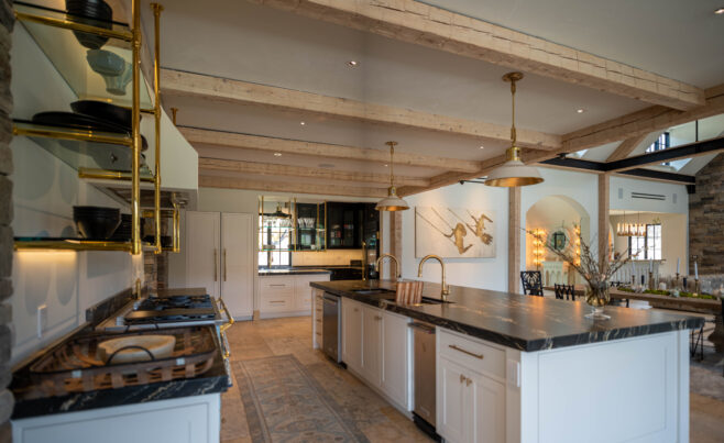 Custom kitchen with hand hewn ceiling beams and marble countertops