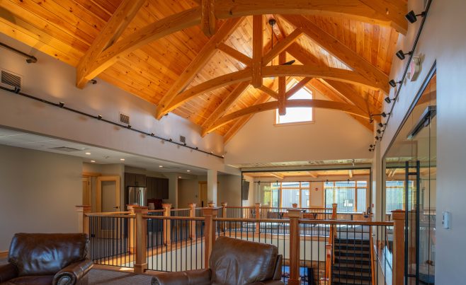 Arched Timber Frame Trusses with Chairs and a Window