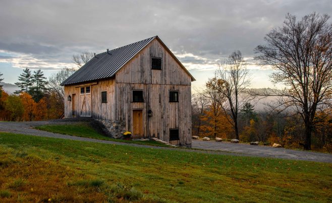 Exterior view of a post and beam bank barn with barn board siding.