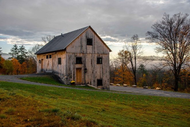 Exterior view of a post and beam bank barn with barn board siding.