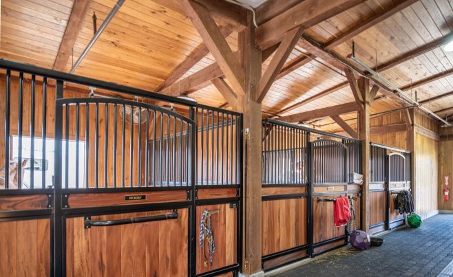 Custom stall hardware in a post and beam horse barn
