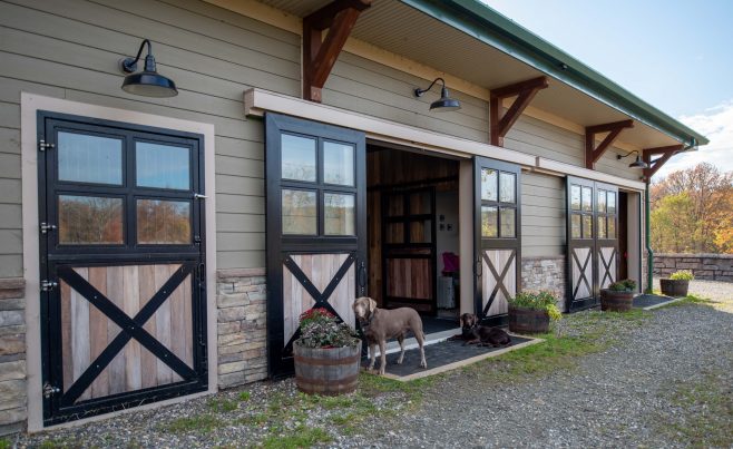 Custom timber brackets under the barn roof overhangs.
