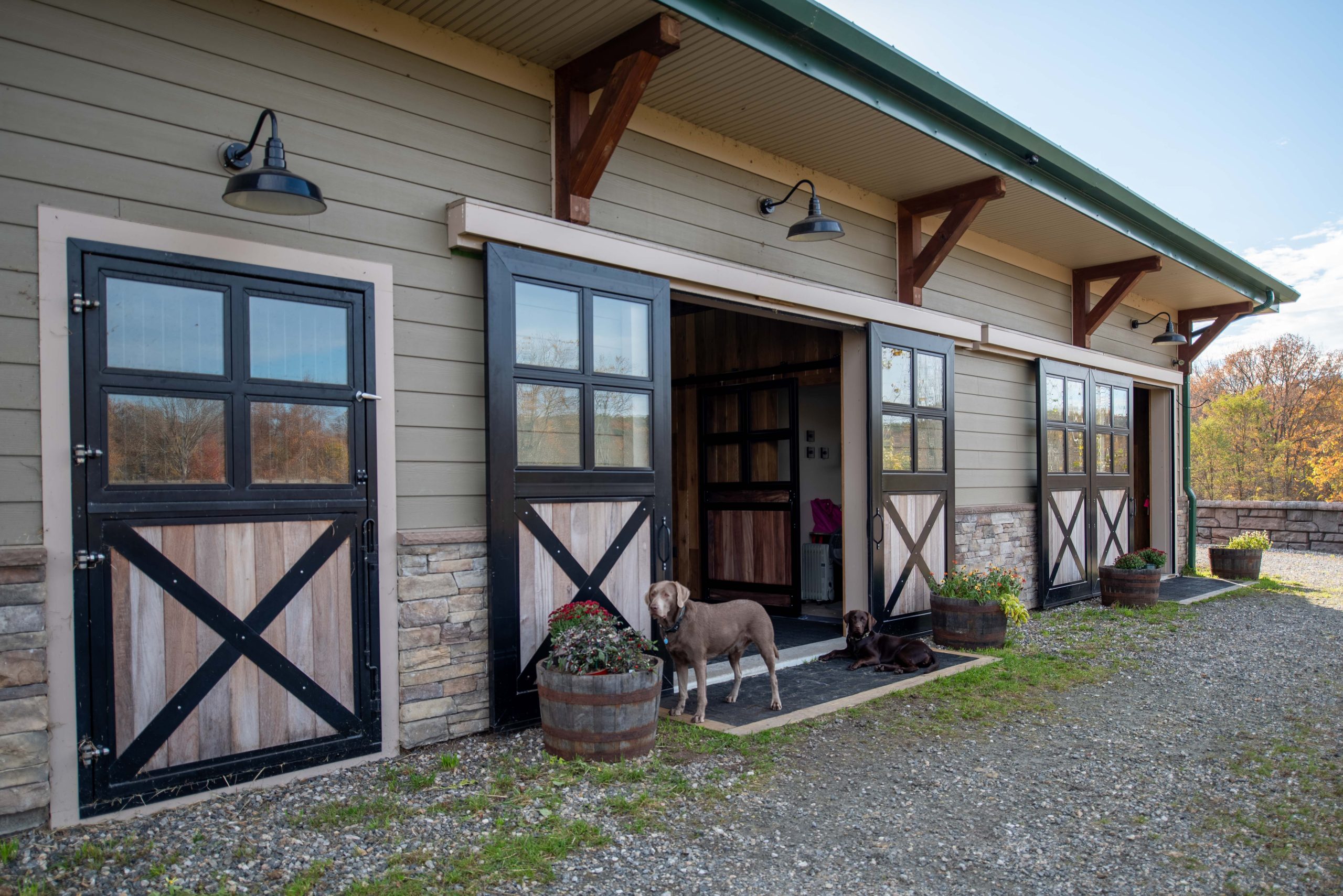 Custom timber brackets under the barn roof overhangs.