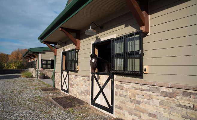 Outside view of a post and beam horse stable