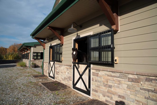 Outside view of a post and beam horse stable