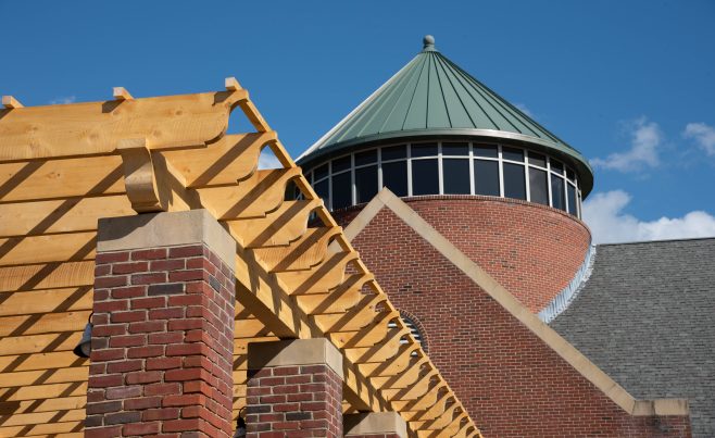 Scrolled rafter tails and wood trellis work.