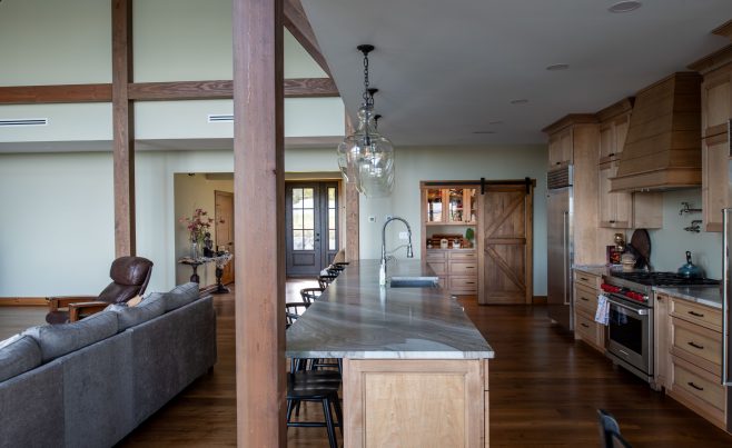 Kitchen with marble counter tops and post and beam framing