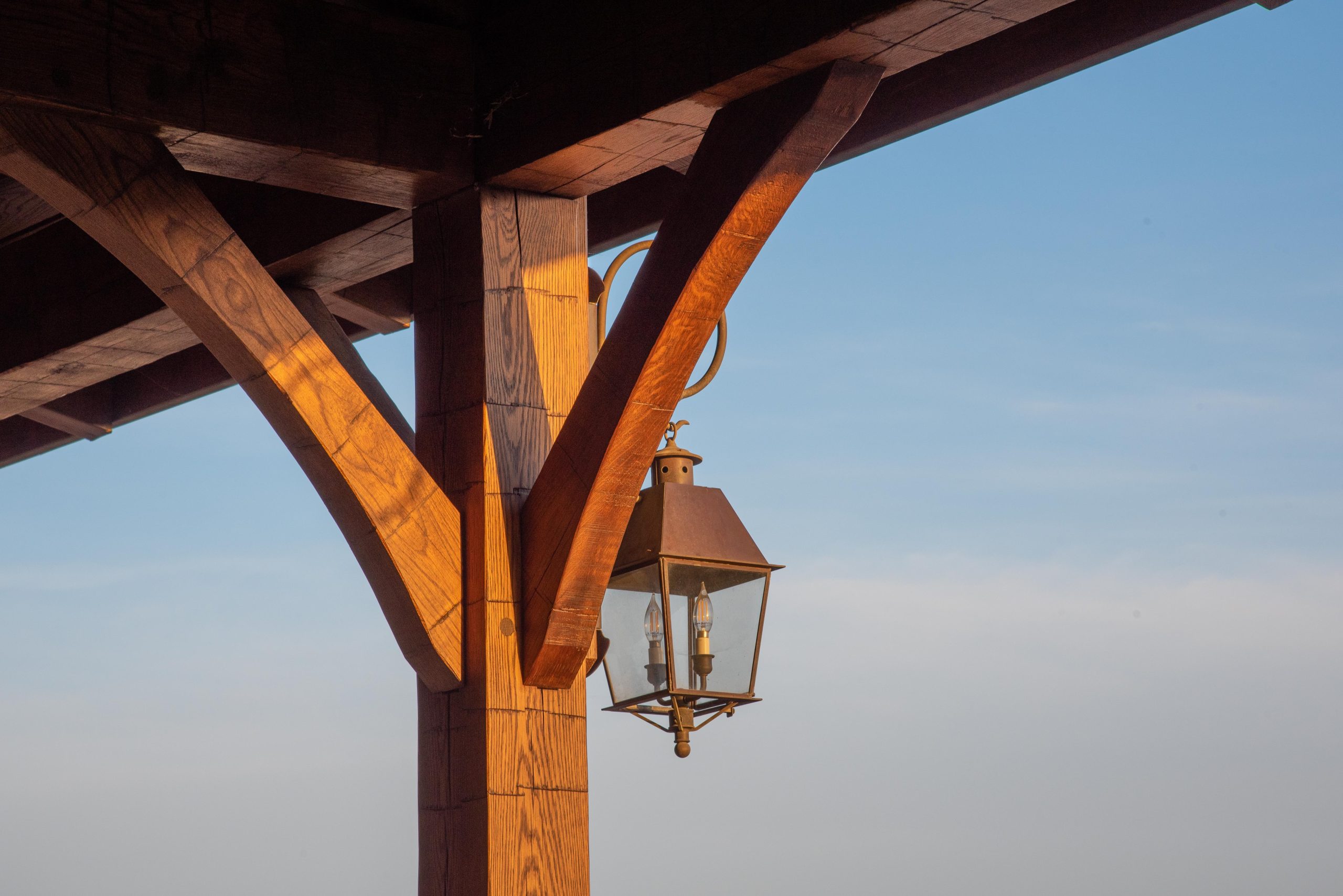 Hand hewn oak timber frame detail with a pretty electric lantern.