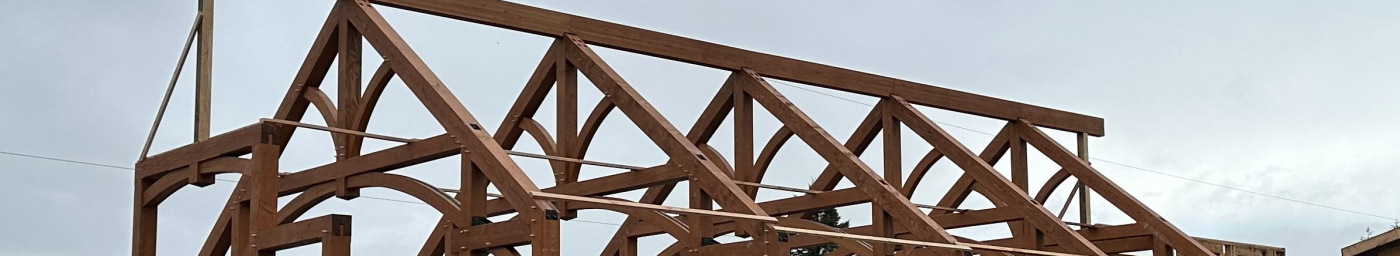 Arched timber trusses space 12 feet apart.