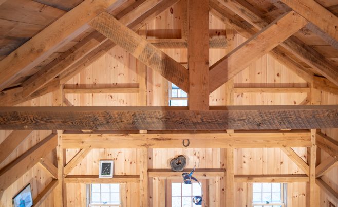 A Rough Sawn Exposed Timber King Post Truss in a cathedral ceiling in a Wood Cottage in VT