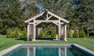 Timber framed pavilion in front of a private swimming pool