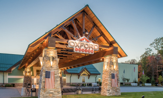 Heavy Timber Porte Cochere with Stone Columns and Steel Accents