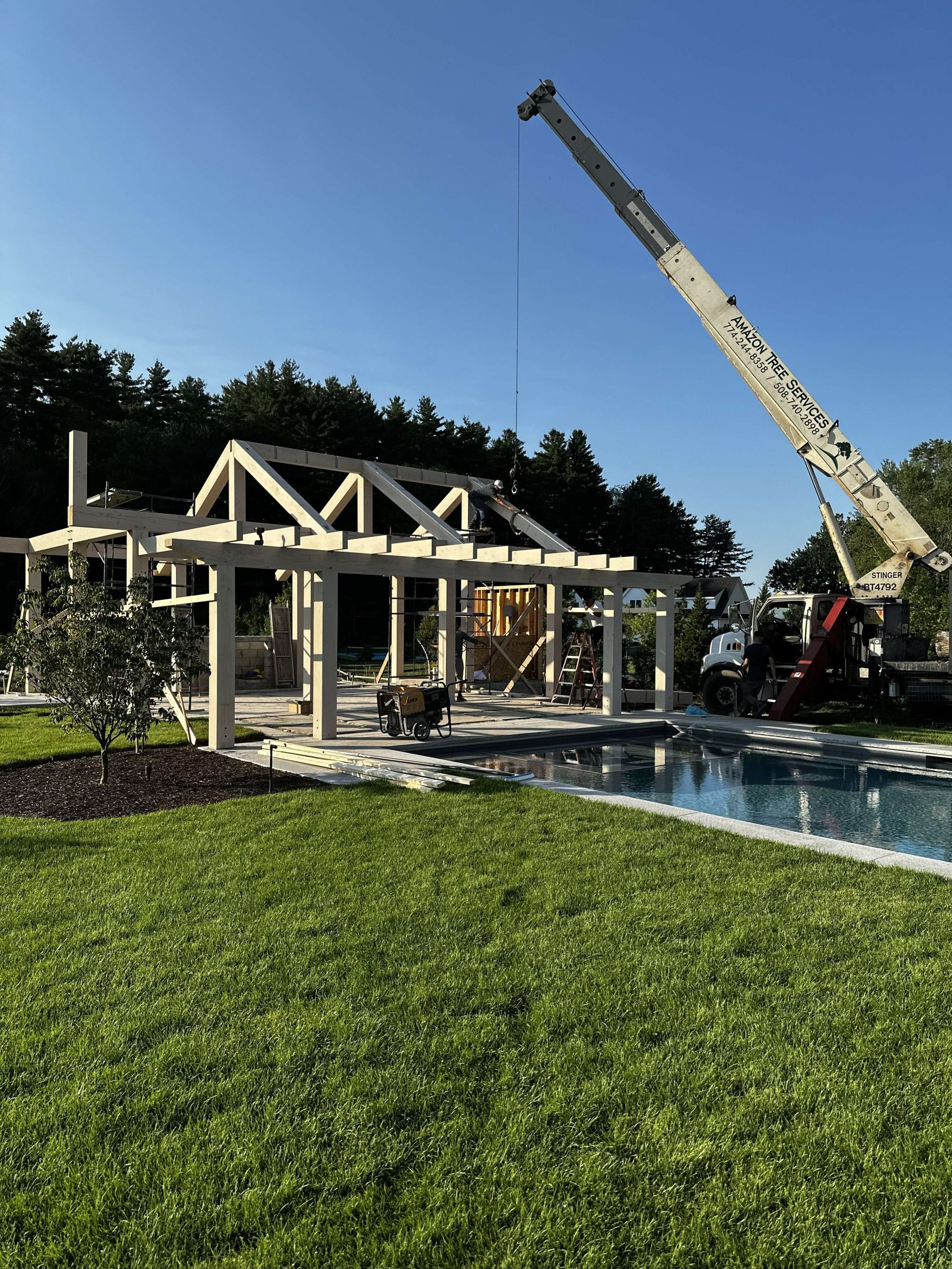 Pool house installation with a crane.