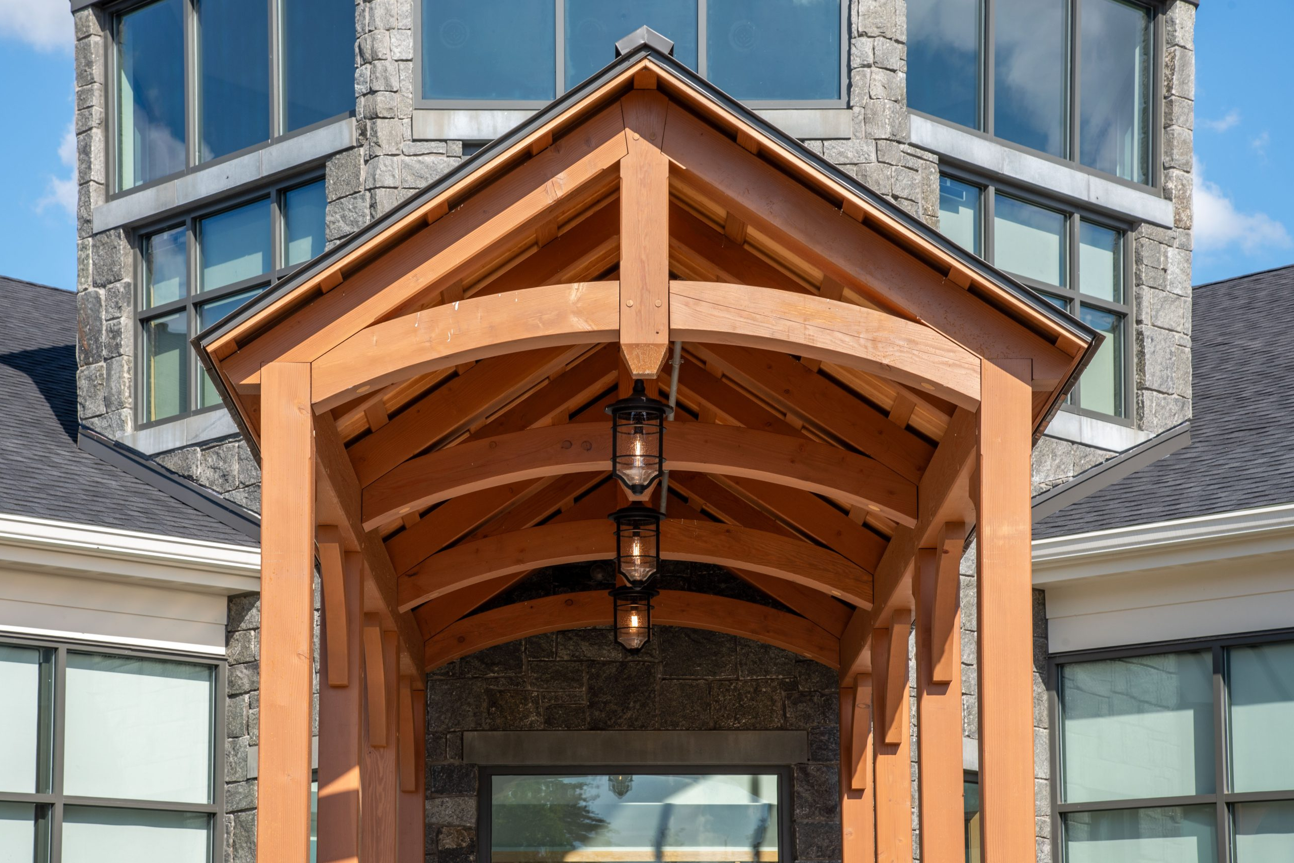 Arched timber truss with hidden steel tie plates
