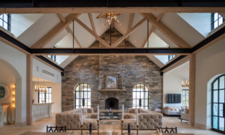 Meyers Residence, NH. Interior of living room with cathedral ceilings with timber trusses with steel beam